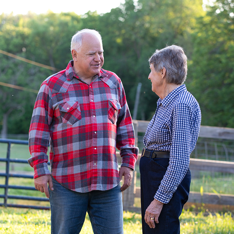 photo of Governor Tim Walz speaking with a constituent in a rural setting