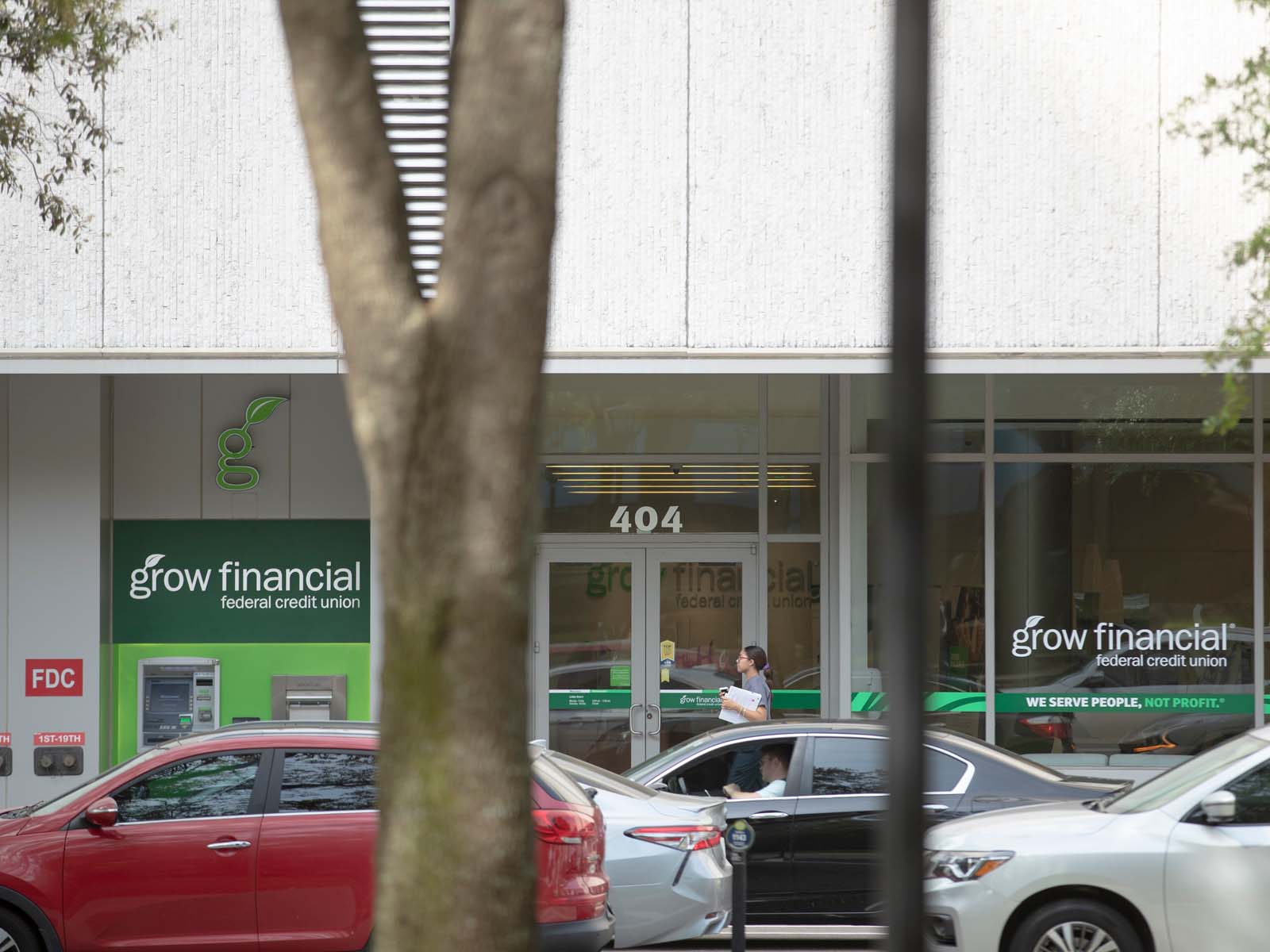 Woman walking in front of Grow Financial storefront